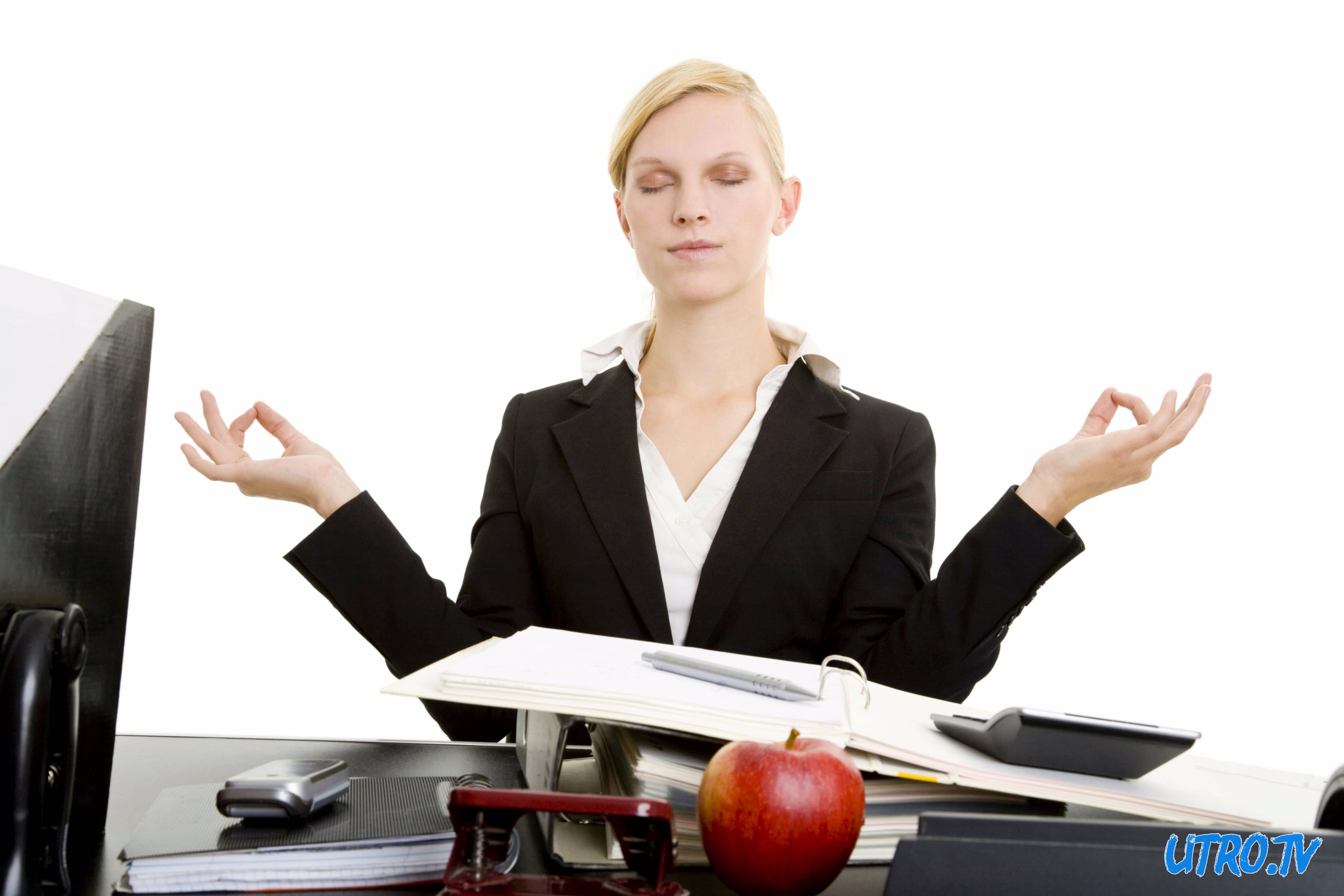 Blond businesswoman meditating at her desk